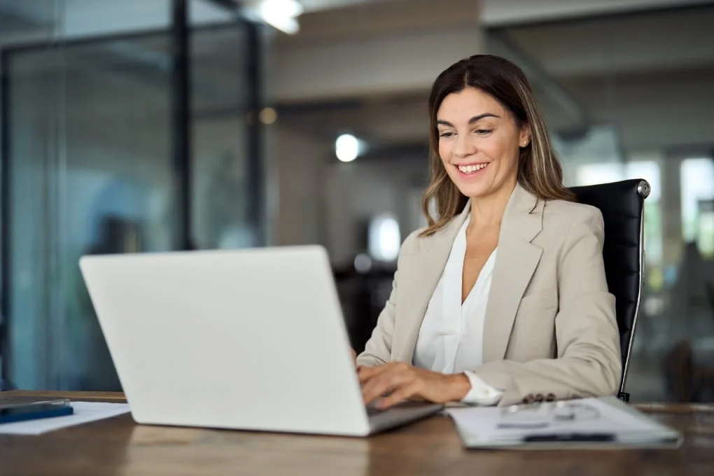 Professional woman using a laptop for secure business data management.